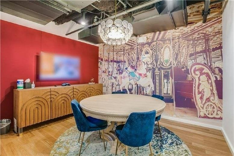 Colorful meeting room at 11 West 42nd Street featuring a carousel mural and blue velvet chairs.