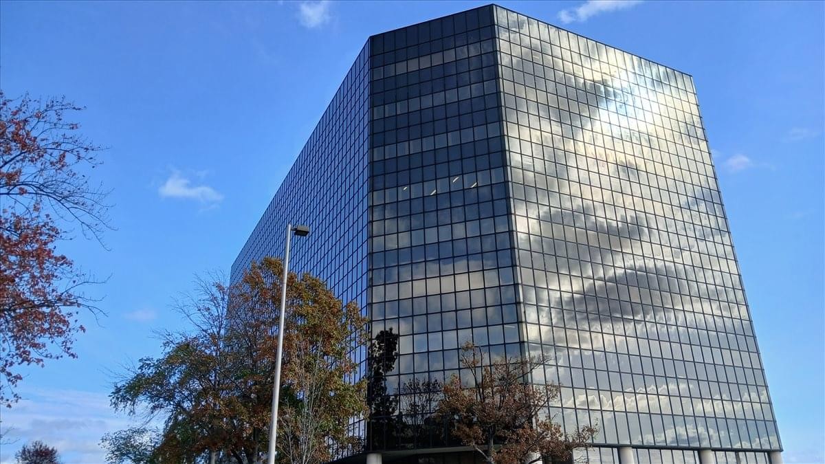 Exterior view of the dark glass facade of Raritan Plaza I at 110 Fieldcrest Avenue.