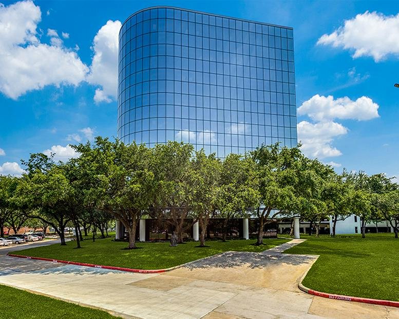 Exterior view of the blue glass curved facade at 11011 Richmond Avenue.