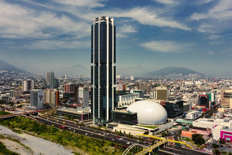 Exterior view of the iconic Pabellón M skyscraper and domed auditorium in Monterrey.