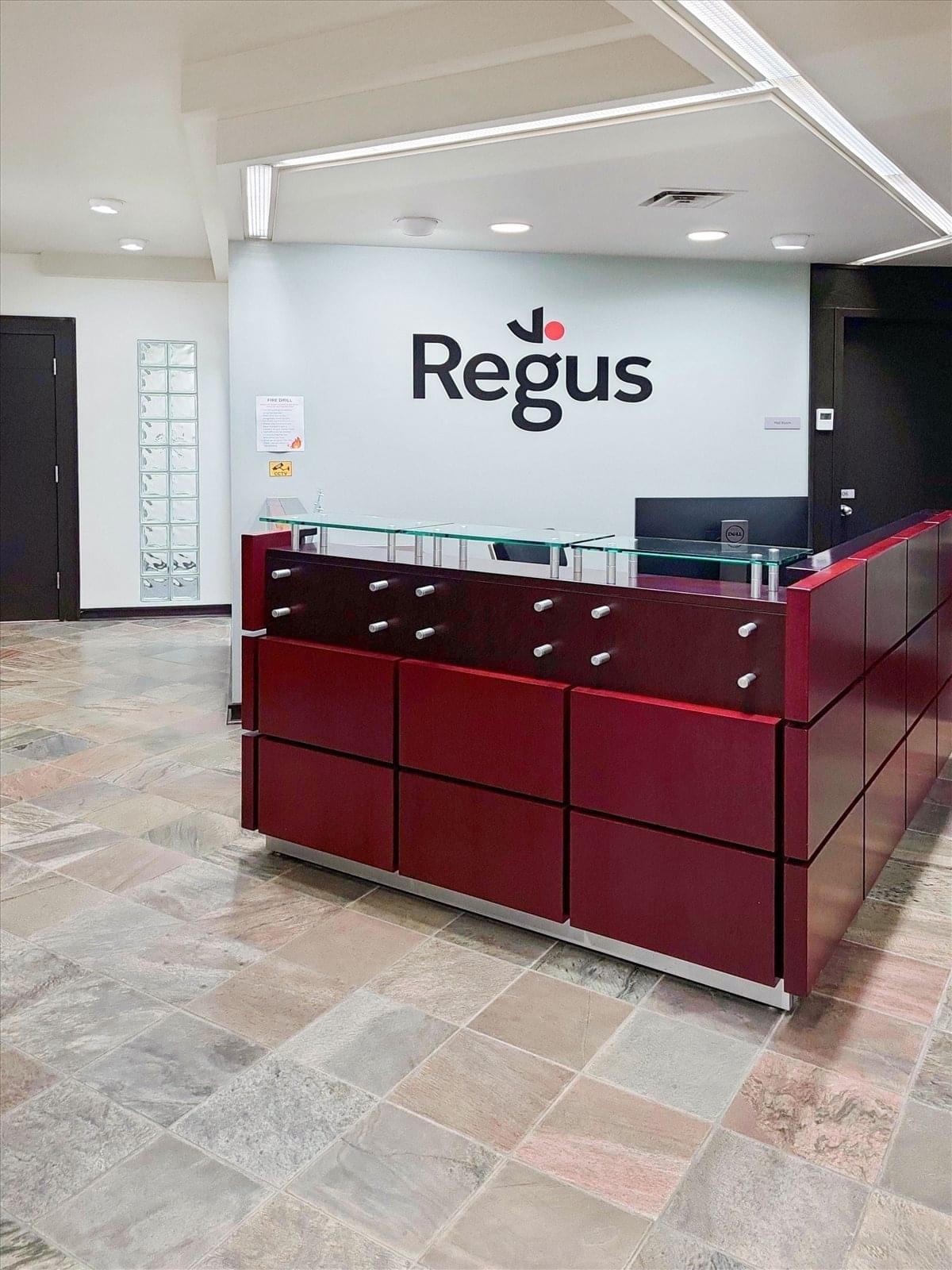 Spacious reception area at 111 2nd Street Avenue with a sleek maroon desk and glass top.