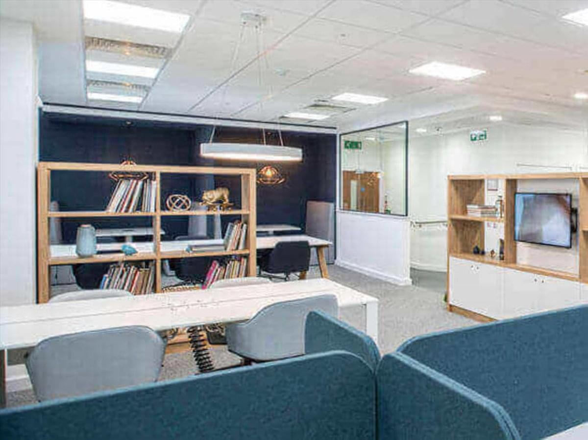 Contemporary breakout space at 1110 Montlimar Drive, 9th Floor, Montlimar Place Office Park with wooden shelving.