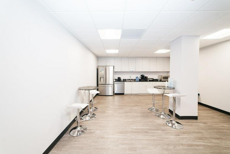 Bright communal kitchen and breakout area at 11166 Fairfax Boulevard, Suite 500.