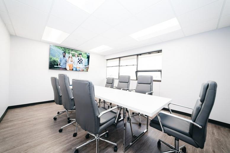 Spacious boardroom at 11166 Fairfax Boulevard, Suite 500 featuring a large table and ergonomic chairs.