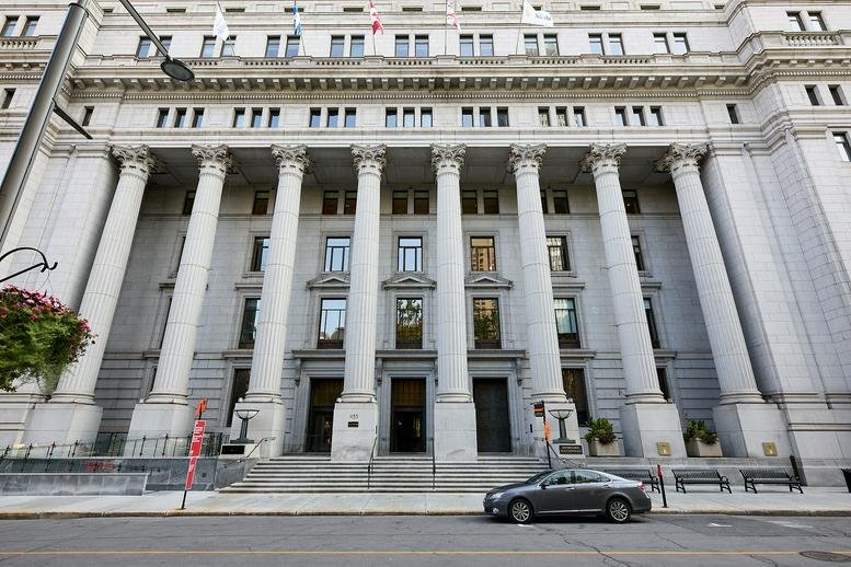Grand stone facade of the historic 1155 Metcalfe Street building featuring classical columns.