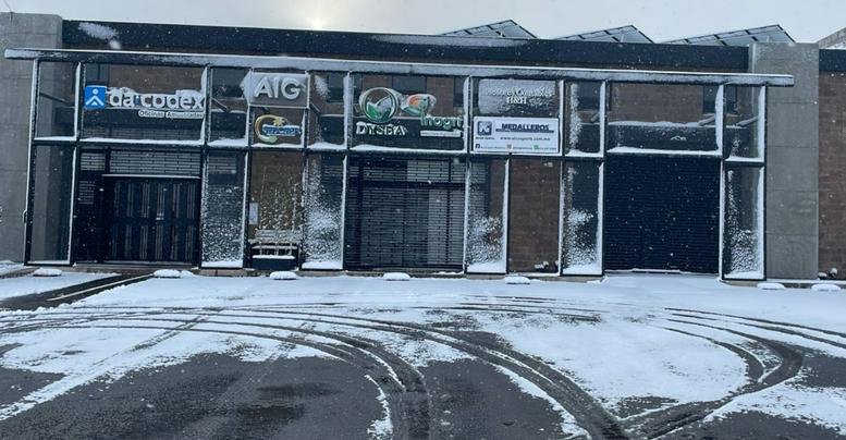 Street-side view of the building exterior during winter with snow-covered ground.