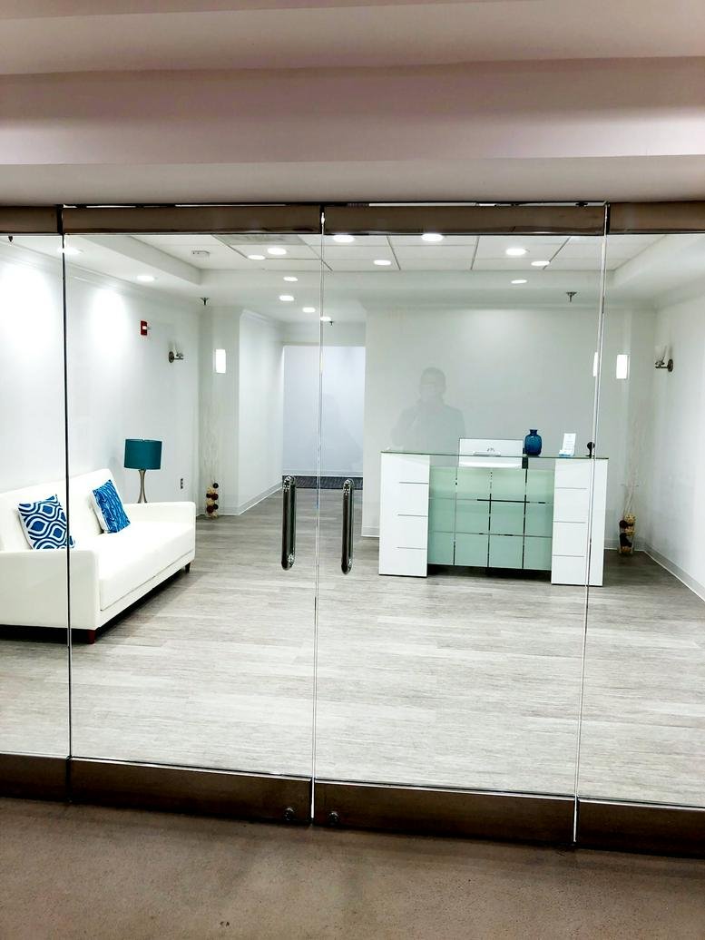 Bright glass-walled entrance to the 11720 Beltsville Drive, Suite 500 office space.