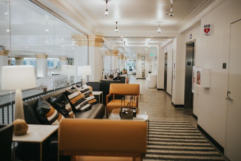 Spacious reception lounge at 120 19th Street North, Suite 200, Birmingham (Alabama) with leather sofa and armchairs.