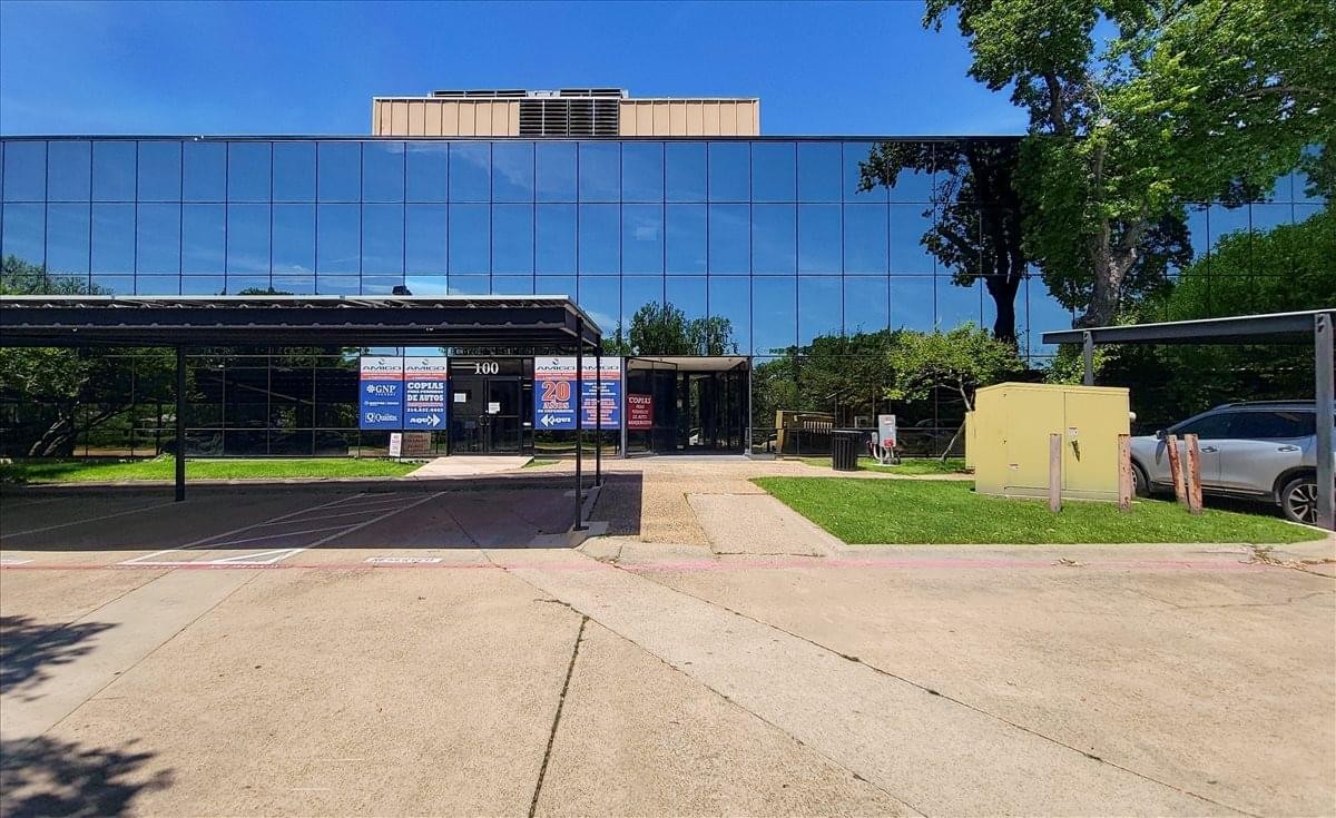 Exterior view of the professional glass-facade building at 1220 River Bend Drive.