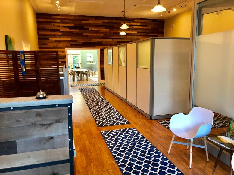 Spacious reception area at 125 South Lexington Avenue, Suite 101, Asheville with wood-paneled walls and patterned rugs.