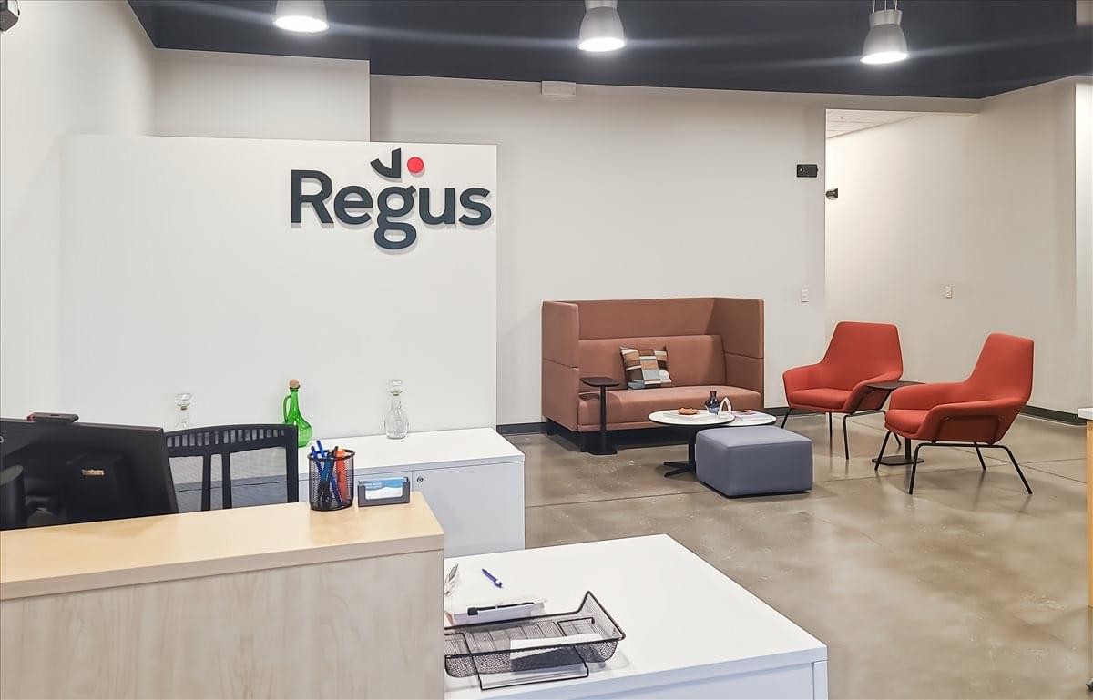 Reception area at 12709 East Mirabeau Parkway showing branded signage and a comfortable waiting lounge.