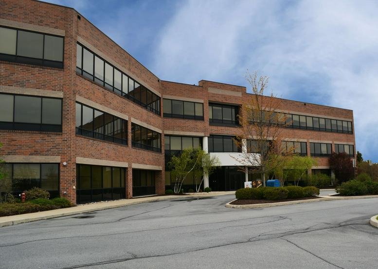 Exterior view of the brick facade at 1275 Glenlivet Drive, Suite 100.