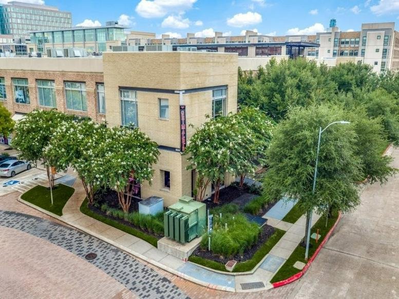 Exterior view of the tan brick building at 12848 Queensbury Lane, Suite 208, Houston, Texas.
