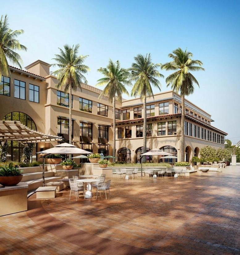 Exterior view of the Mediterranean-style building at 1300 El Camino Real, Suite 100, Menlo Park, California.