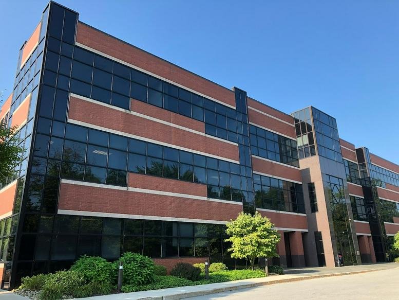 Exterior view of the brick and glass facade at 1320 Hausman Road, Suite 200.