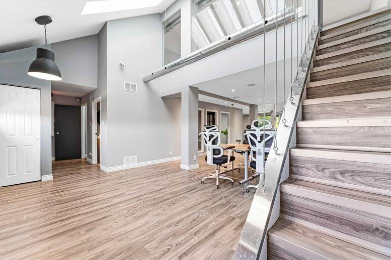 Spacious entrance at 1338 Wellington Street W with light wood floors and vaulted ceilings.