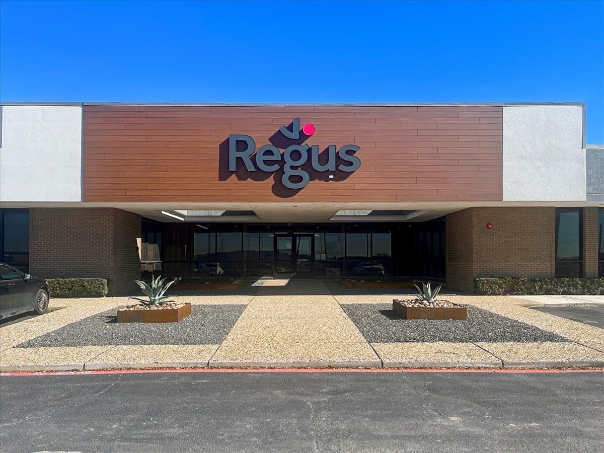 Exterior entrance of the 13509 Lyndon B Johnson Freeway office building with Regus branding.