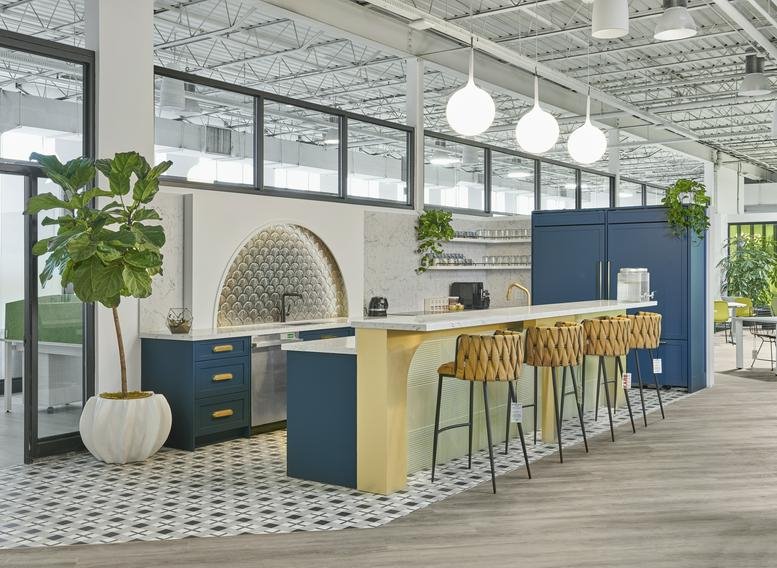 Contemporary kitchen island with blue cabinetry, globe pendant lights, and bar stool seating.