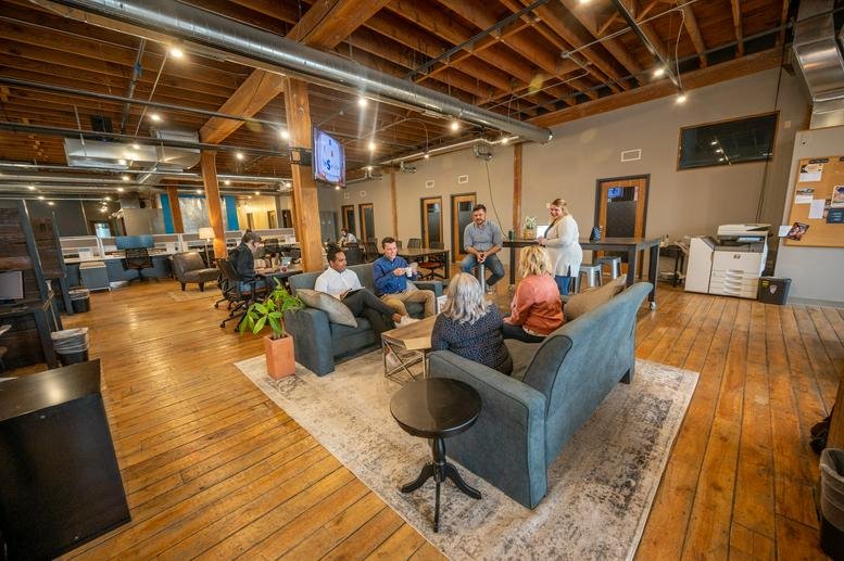 Spacious open-plan communal area at Van Buren Building with comfortable seating and wood floors.
