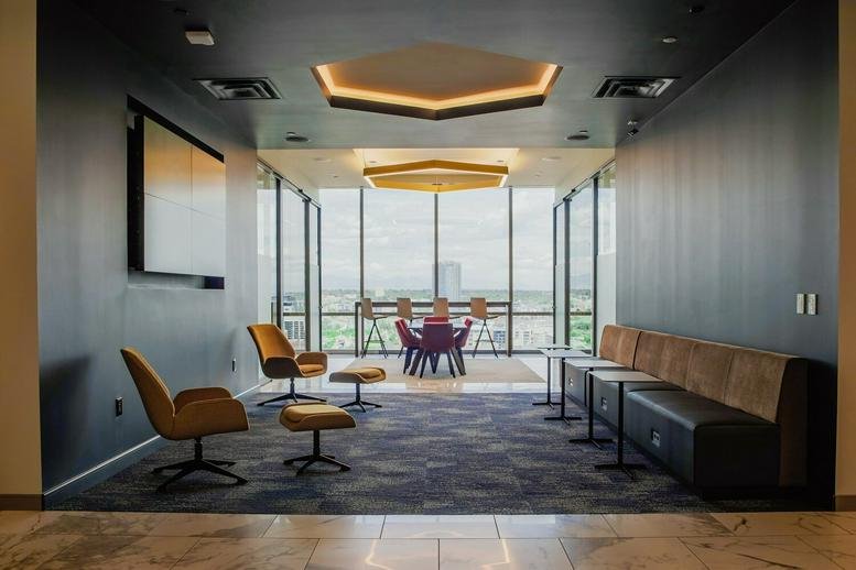 Modern lounge at 1401 Lawrence Street, 16th Floor with colorful seating and floor-to-ceiling windows.