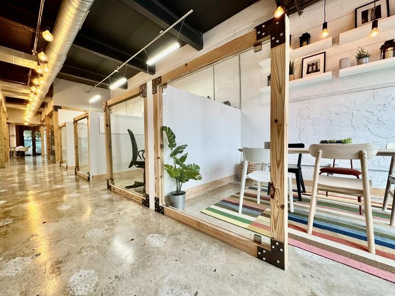 Spacious sunlit lobby and coworking area at 142 NW 37th St, Miami, Florida.