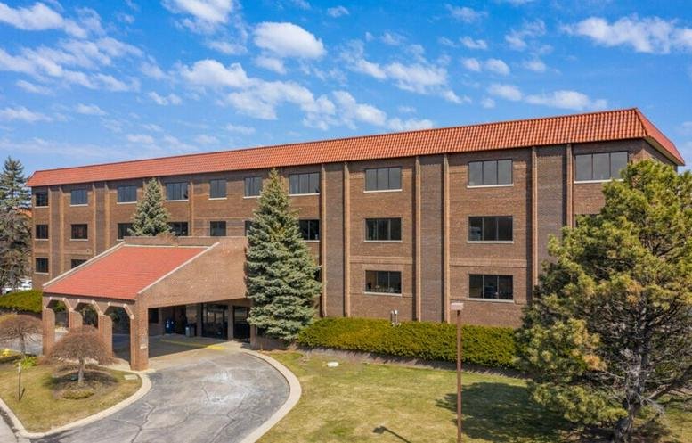 Exterior view of the brick facade and entrance at 1440 Renaissance Drive, Park Ridge, Illinois.