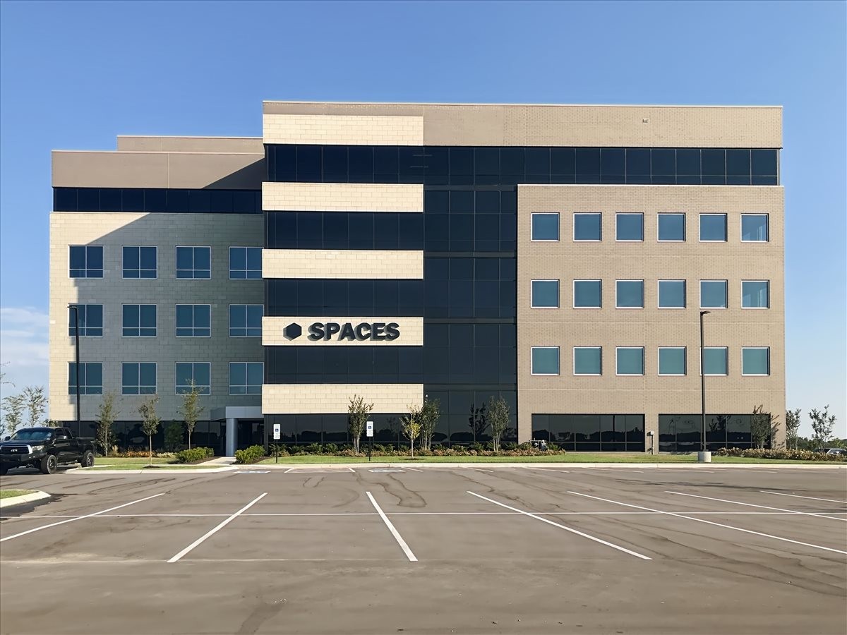 Exterior of SPACES building with large glass windows.