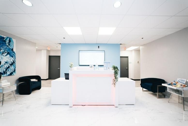 Bright reception area at 14502 Greenview Drive, Suite 400, Laurel (Maryland) with a blue feature wall.