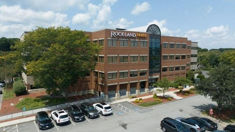 Exterior view of the brick and glass building at 150 Grossman Drive, Suite 203.