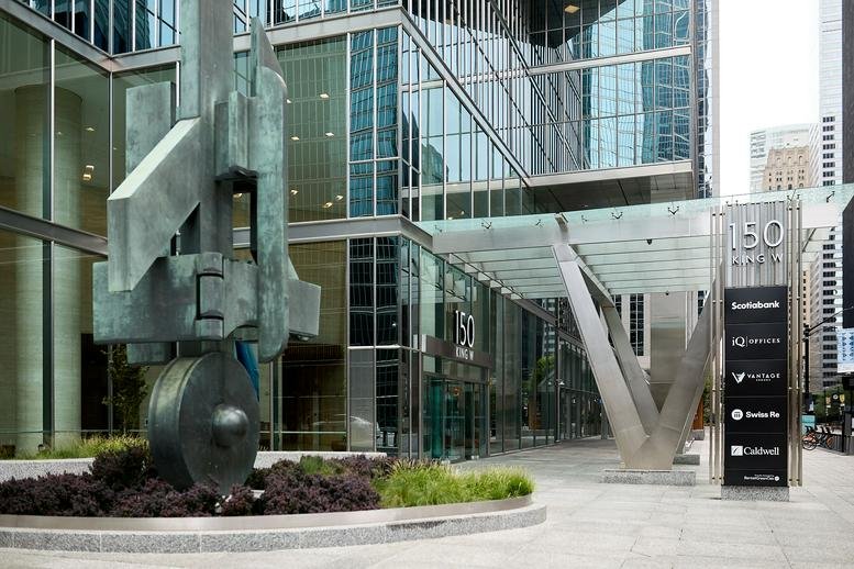 Exterior view of the modern glass facade and main entrance at 150 King St West, Toronto, Ontario.