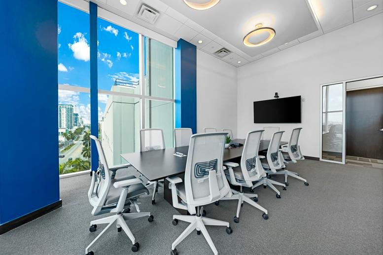 Conference room at OMNI Center with a long table, ergonomic chairs, and floor-to-ceiling windows.