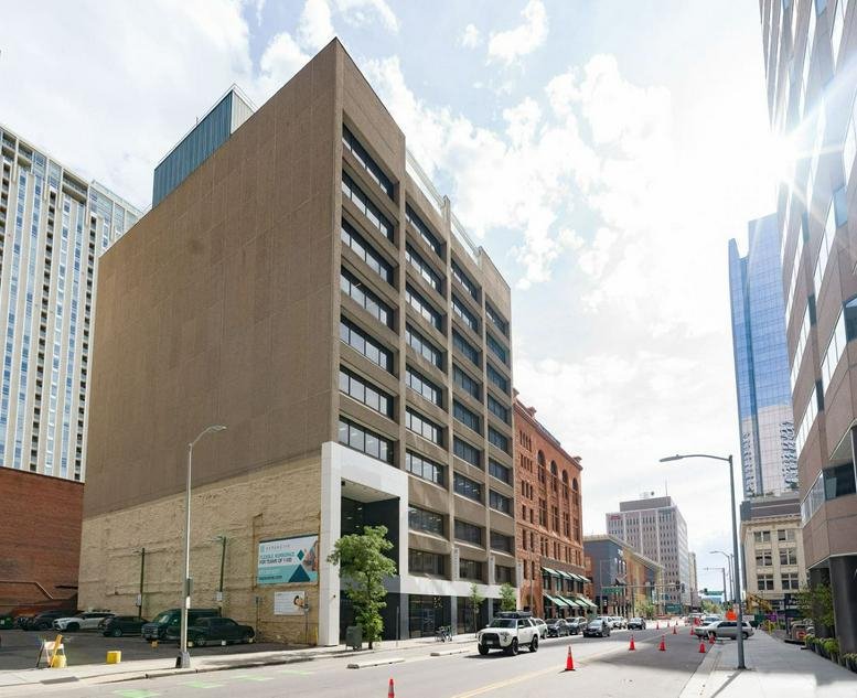 Exterior view of the tall, brown multi-story building at 1630 Welton Street.