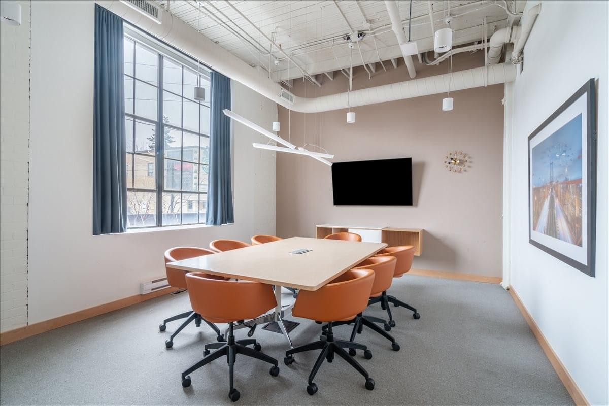 Spacious boardroom at 1655 Dupont Street with a long table and tan swivel chairs.
