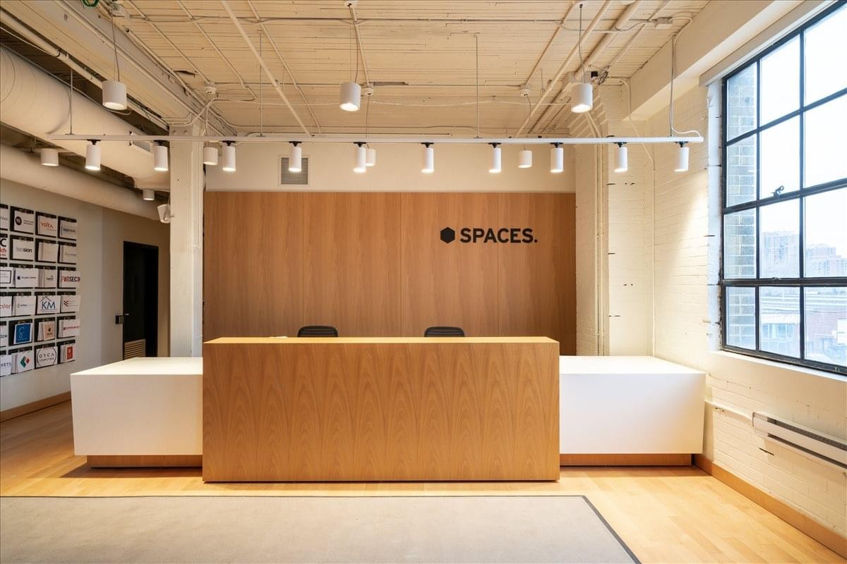 Minimalist wood-panelled reception desk at 1655 Dupont Street, Suite 101.