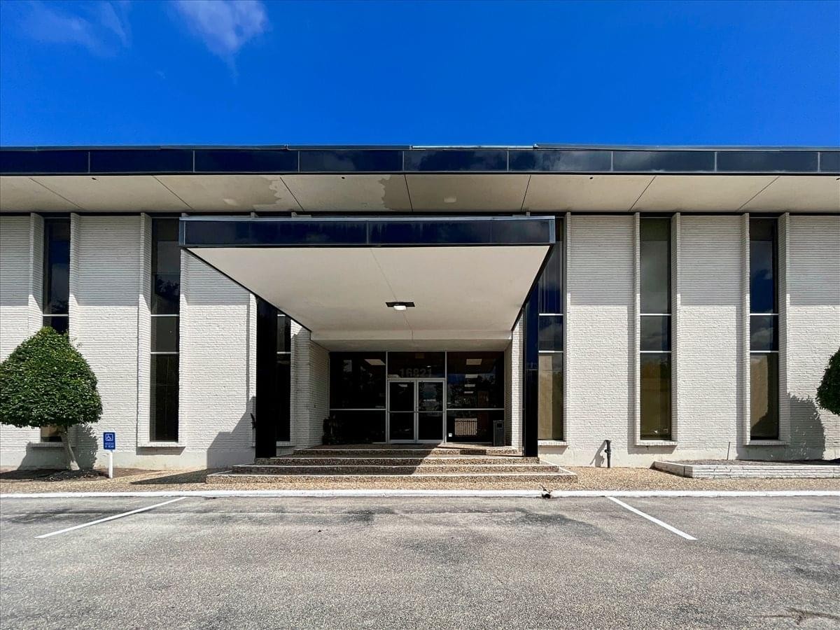 Symmetrical front view of the building entrance and glass facade.