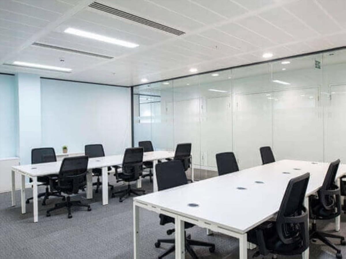 Spacious open-plan workspace at 16868 Via Del Campo Court featuring white desks and a glass-walled conference room.