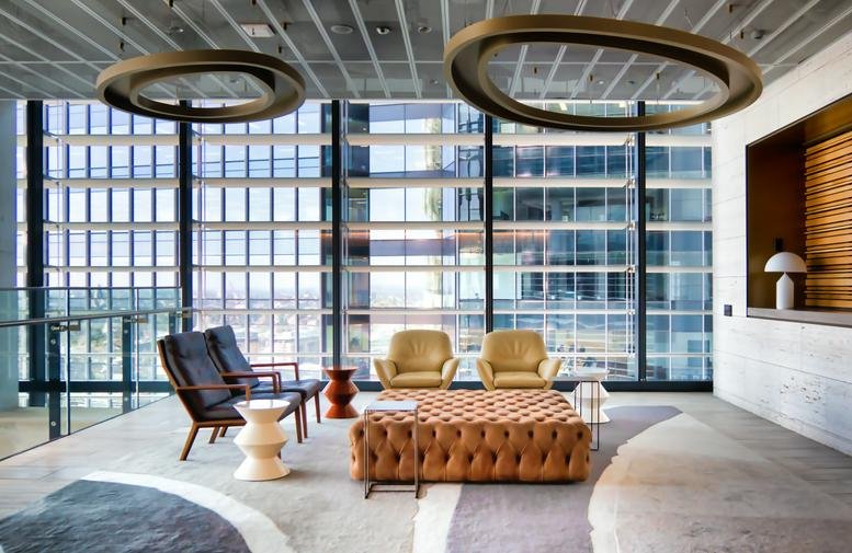 Bright, modern lobby at 1727 Snyder Avenue with leather ottomans and floor-to-ceiling windows.