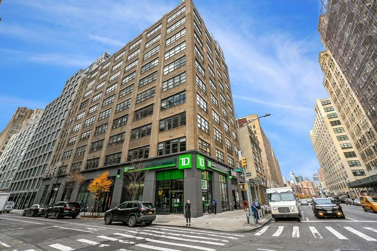 Exterior view of the multi-story brick facade at 175 Varick Street, Floors 1, 2 & 4, Hudson Square.