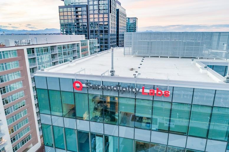 Exterior view of the modern glass facade building at 1801 Wewatta Street.