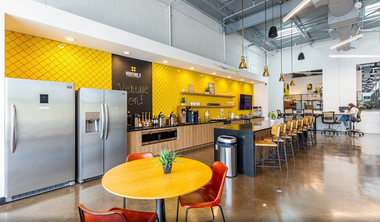 Shared kitchen area at 1806 Summit Avenue, Suite 300, featuring yellow accents and modern appliances.