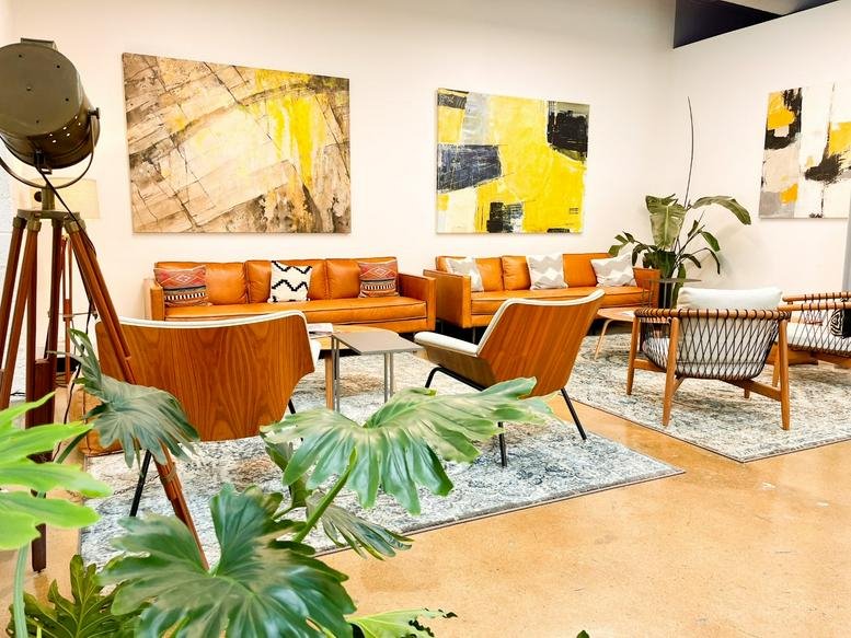 Modern lounge area at 1806 Summit Avenue, Suite 300 with leather sofas and abstract art.
