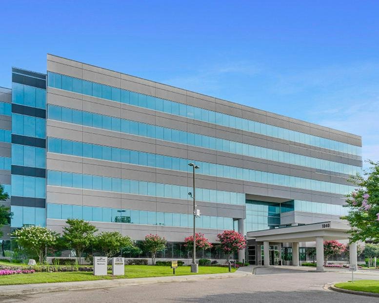 Exterior view of the modern multi-story glass building at 1840 Pyramid Place.