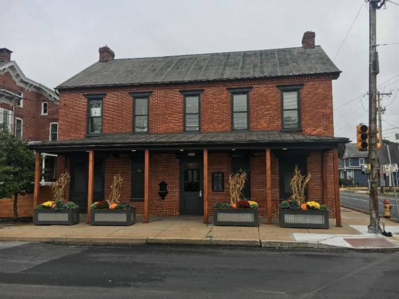 Full exterior view of the two-story red brick building at 1987 State Street, 1st Floor.