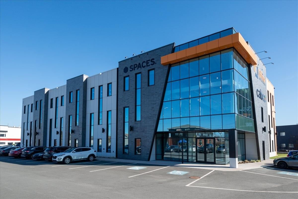 Exterior view of the modern glass and masonry facade at 2 Ralston Avenue, Suite 100.