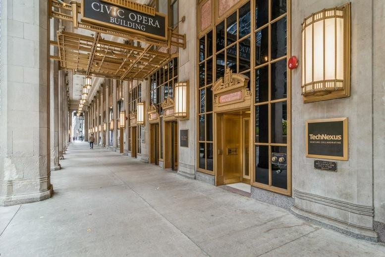 Entrance to the Civic Opera Building with gold accents and signage.