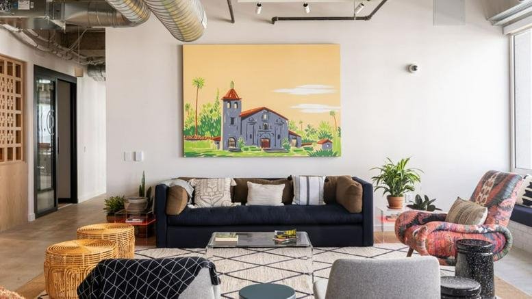 Spacious communal lounge at 200 Berkeley Street with a navy blue sofa and colorful church mural art.