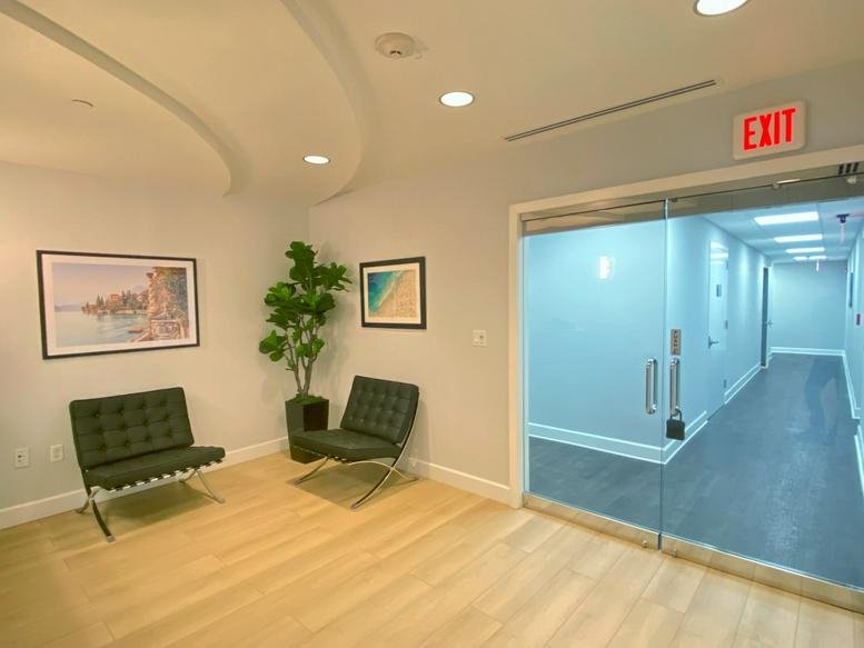 Spacious reception area with modern armchairs and artwork at Museum Plaza, Suite 504.