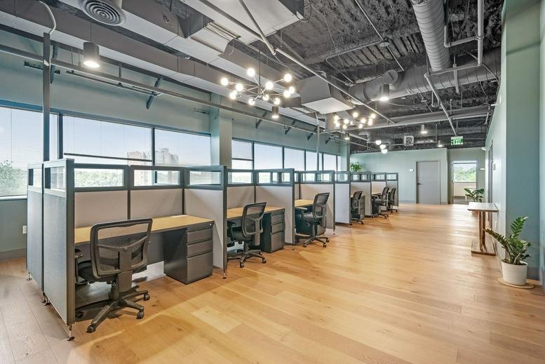 Spacious open coworking area at 200 Washington Avenue with wooden floors and industrial ceilings.