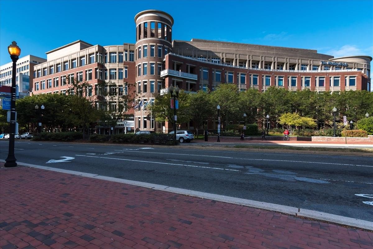 Exterior view of the classic brick facade and rounded turret at 2000 Duke Street, Suite 300.