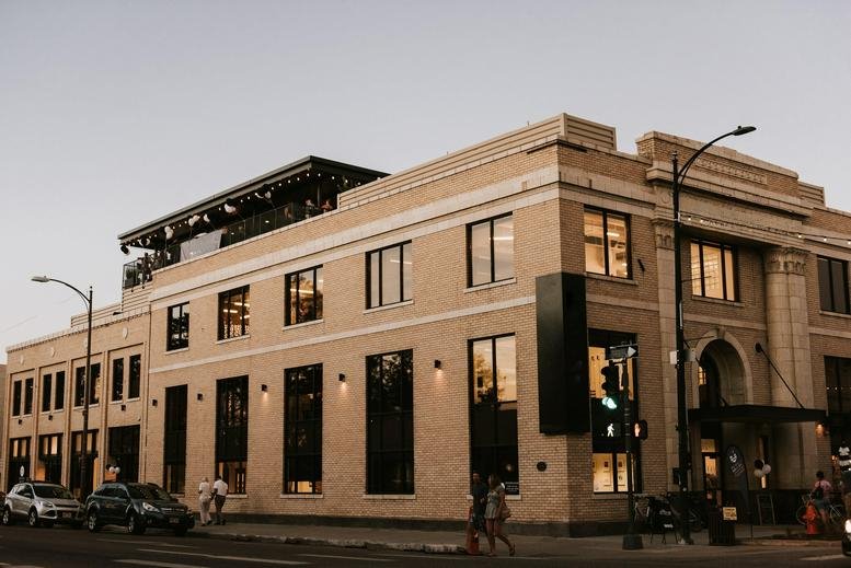 Exterior view of the historic light-colored stone facade of 201 East 4th Street, Loveland, Colorado.